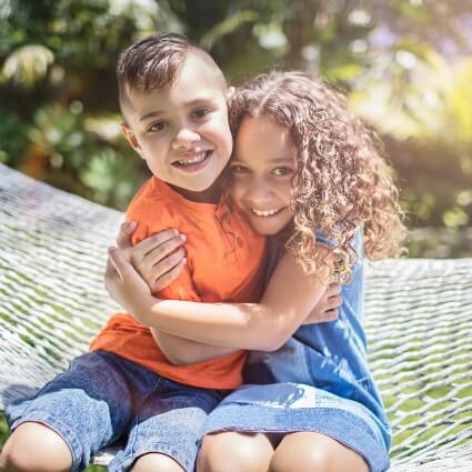 Brother and sister hugging