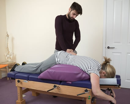 Adjusting pregnant patient on table