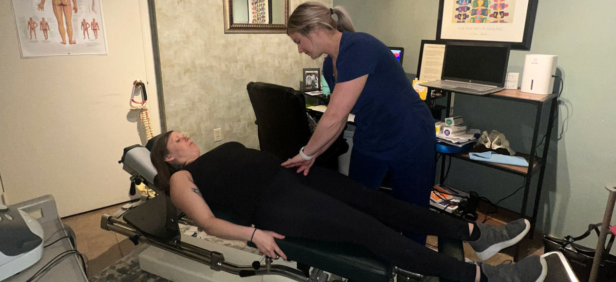 Chiropractic pressing patient's belly