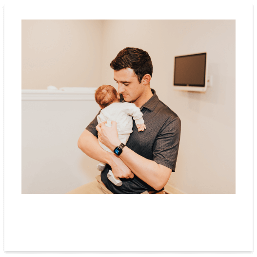 Dr. Zac Pinter holding his baby