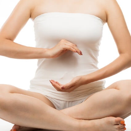 woman with her hands over gut