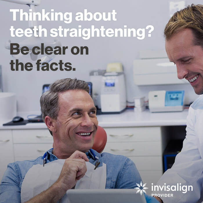 man getting fitted with invisalign aligners