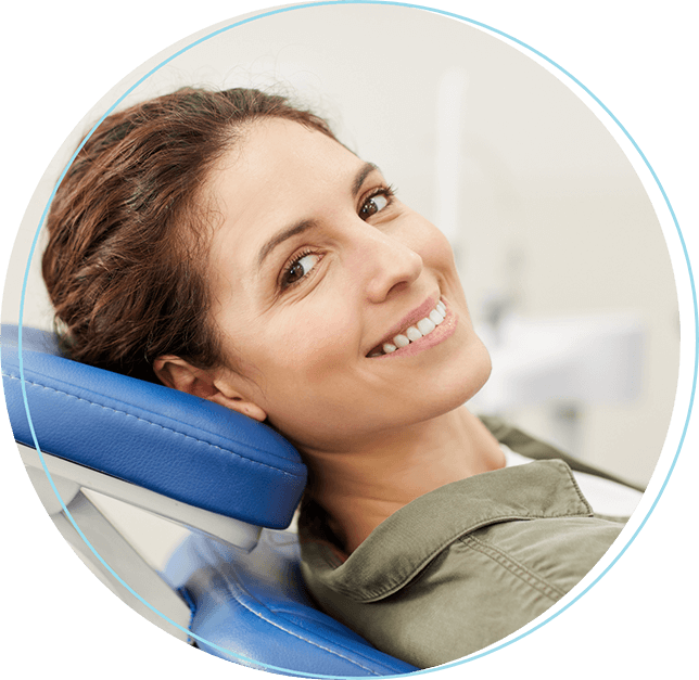 Woman lying back in dental chair and smiling
