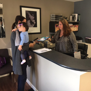 Wells Family Chiropractic Greeting patient