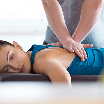 chiropractor adjusting persons back