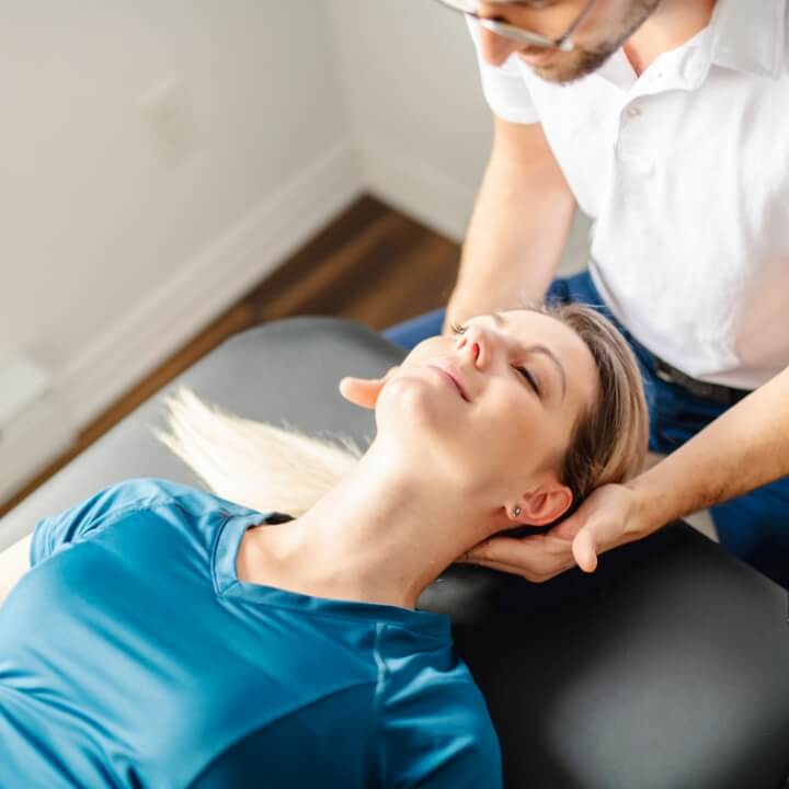 chiropractor adjusting persons neck