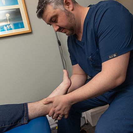 chiropractor adjusting patients foot