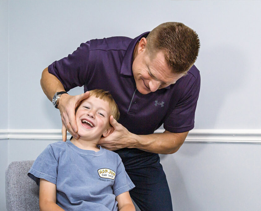 Doctor adjusting child neck