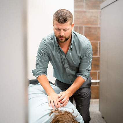Dr. Evan adjusting patient