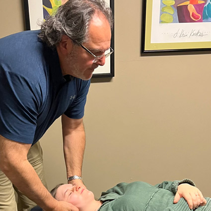 Dr. Arthur Kassis adjusting a patient