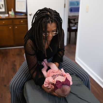 Dr Ashley adjusting baby