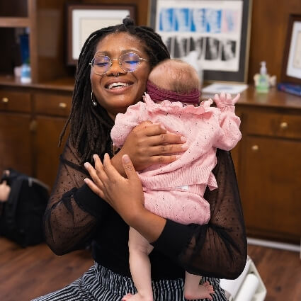 Dr Ashley holding baby