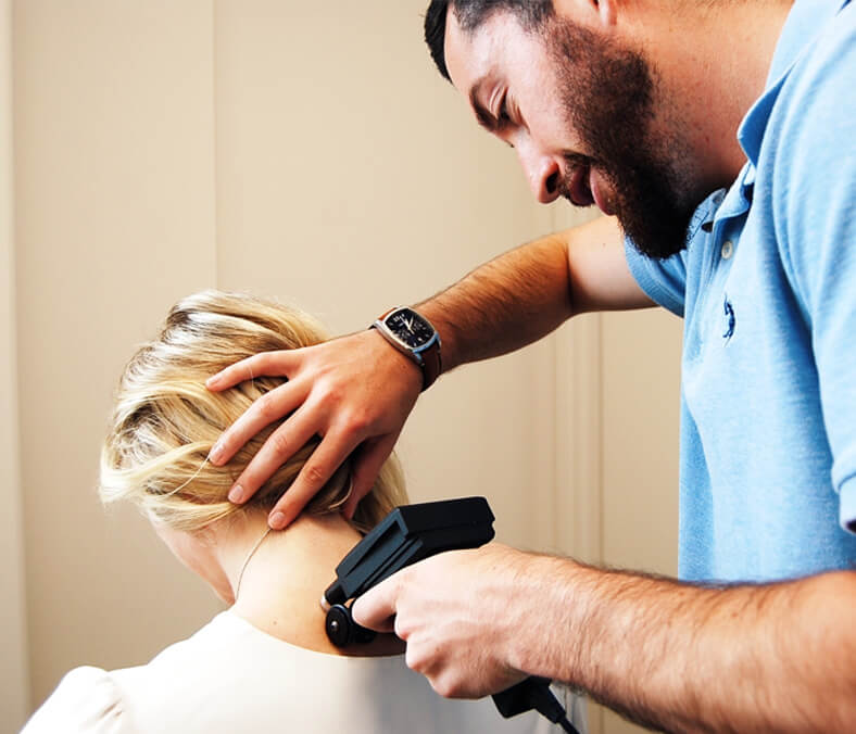 chiropractor scanning patients neck