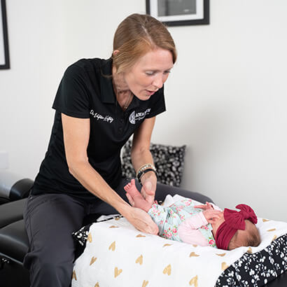 Dr. Victoria Kustarz adjusting an infant