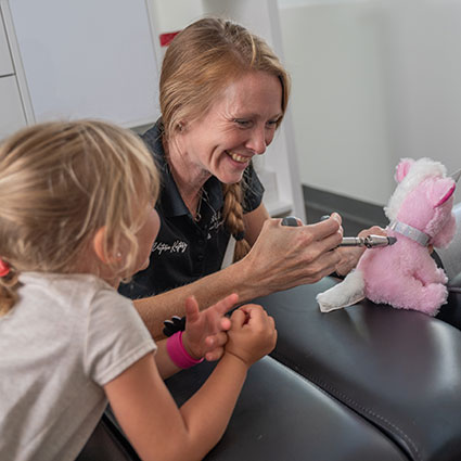 Showing girl adjustment on stuffed animal