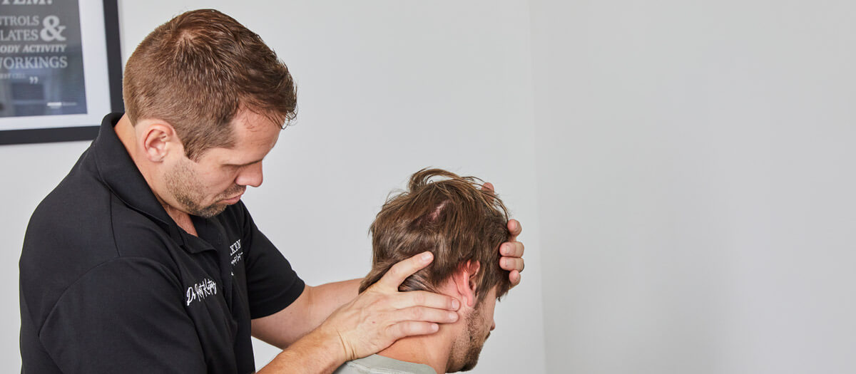 Dr Rober adjusting patients neck