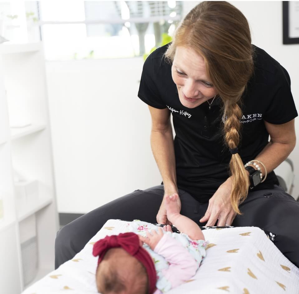 Dr. Victoria Kustarz smiling at baby