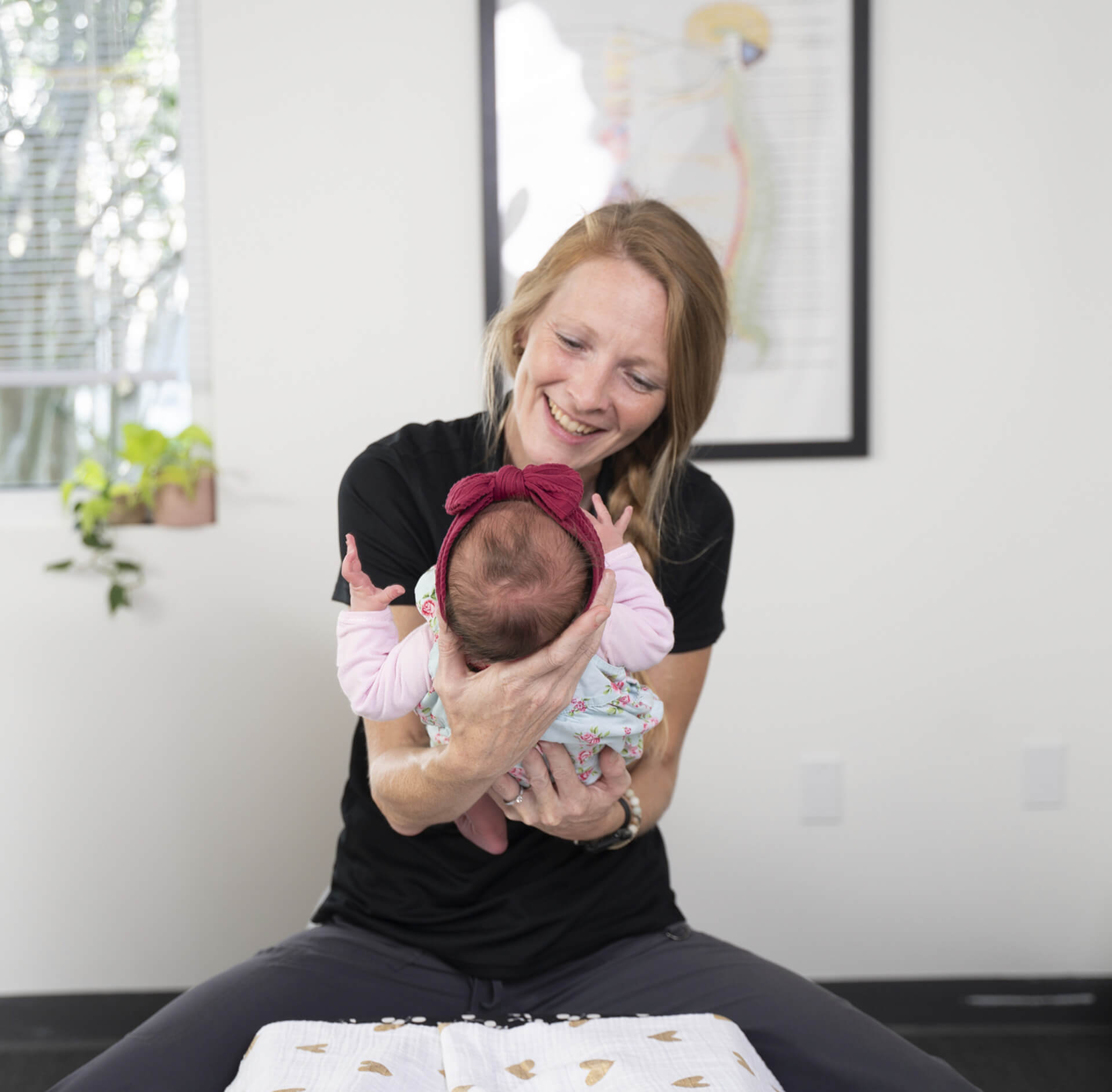 Dr. Victoria Kustarz smiling at baby