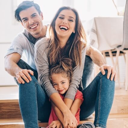 Happy family sitting on the floor