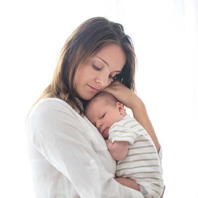 mom carrying little baby