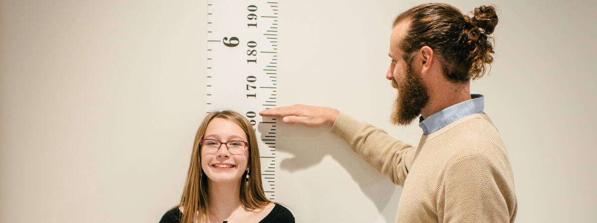 Lee's Summit chiropractor checking little girl's height