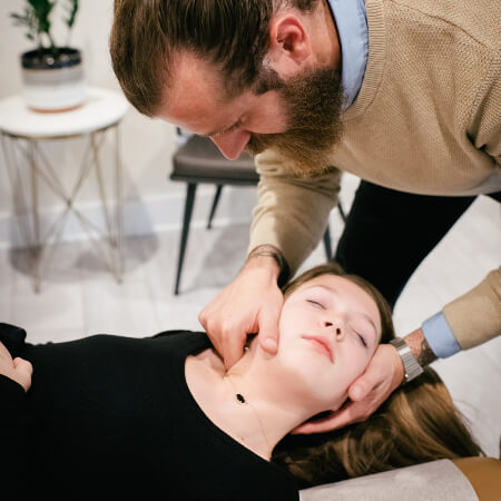 Lee's Summit patient receiving a chiropractic neck adjustment at Brandon Fell Chiropractic