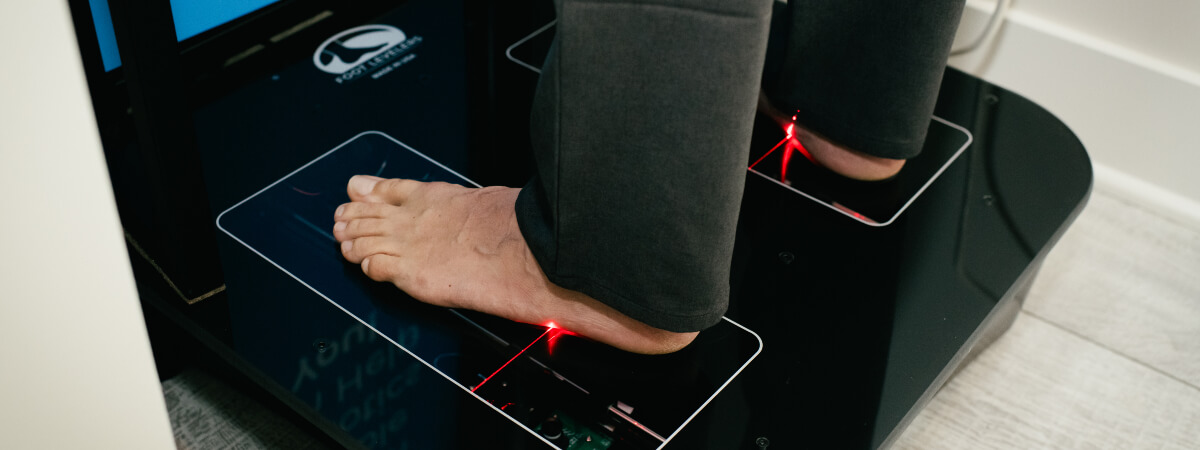 Man getting feet scanned for orthotics