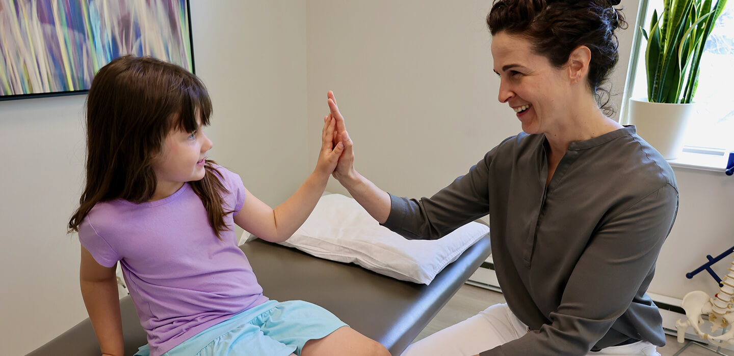 Chiropractor giving high five to a child