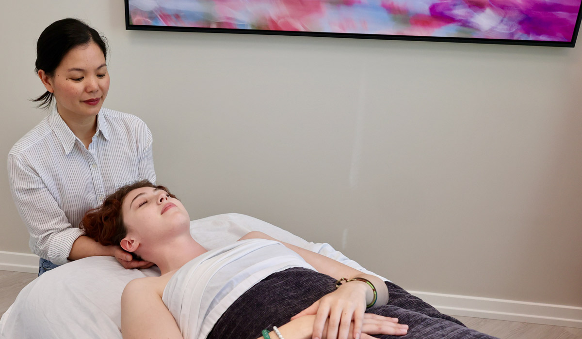 Massage therapist massaging client's head