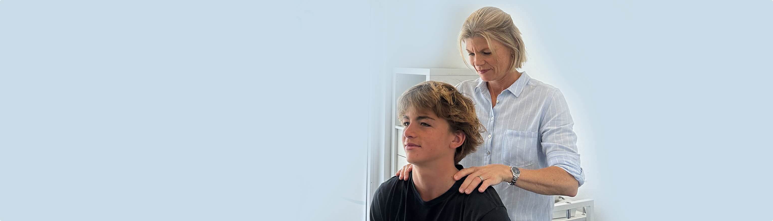 chiropractor adjusting patients shoulder