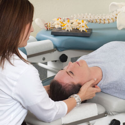 chiropractor adjusting patient