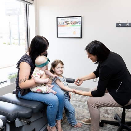 Dr. Carla Santin using activator on child