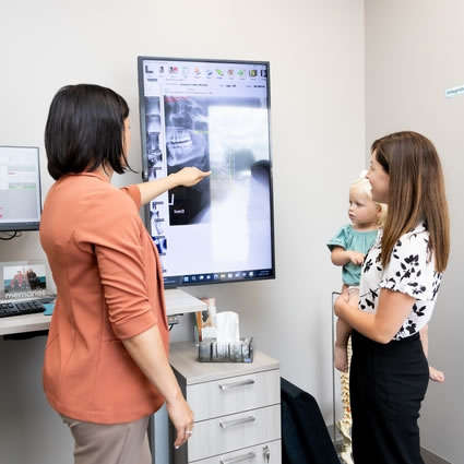 Dr. Carla Santin showing digital x-rays to patient
