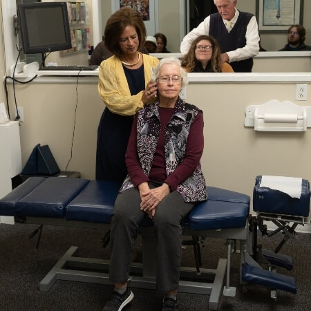 Chiropractor adjusting a female patient