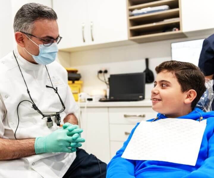 smiling kid in dentist chair 
