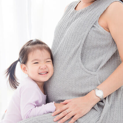 daughter-embracing-her-moms-pregnant-stomach-sq