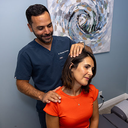 chiropractor adjusting persons neck