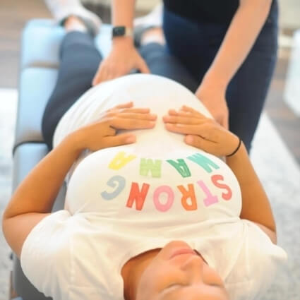 pregnant person being adjusted