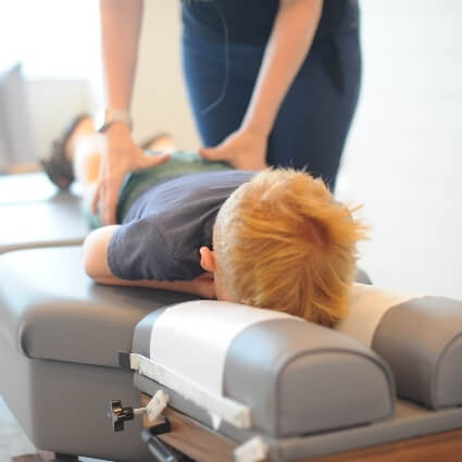 kid having back adjusted