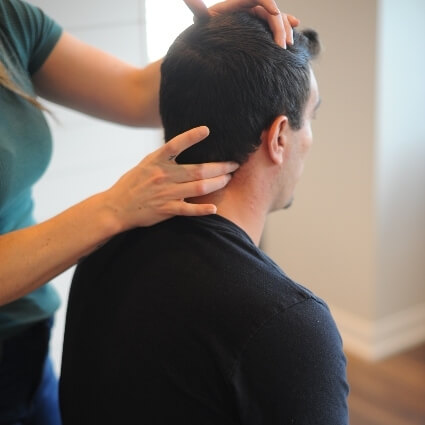 person having neck adjusted