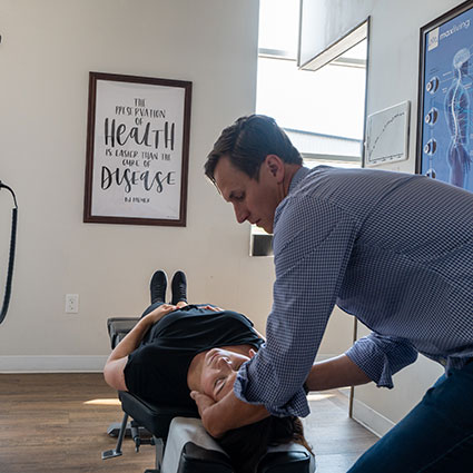 Adjusting woman's neck