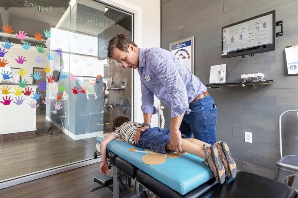 South Austin chiropractor adjusting childs legs