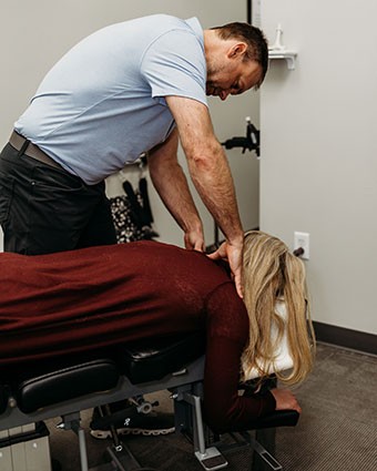 Adjusting woman on table