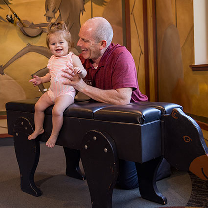 Holding baby on adjusting table