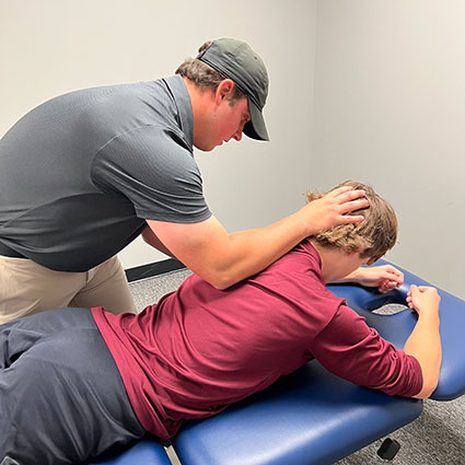 Dr. Hunter with hand on patient's head