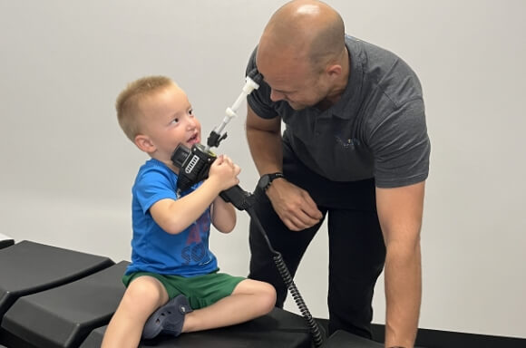 Dr Stephen List playing with kid patient