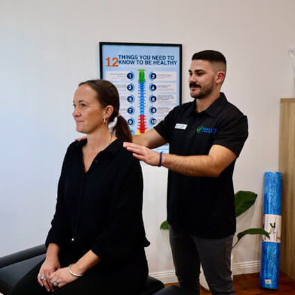 Dr Alex adjusting patients shoulder