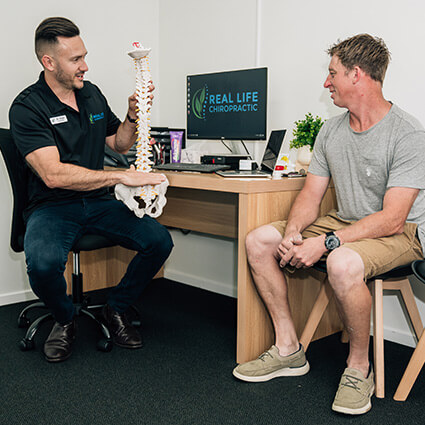 Real Life Chiropractic chiropractor talking with patient