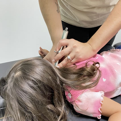 Dr. Ilean Santos performing Torque Release technique on child