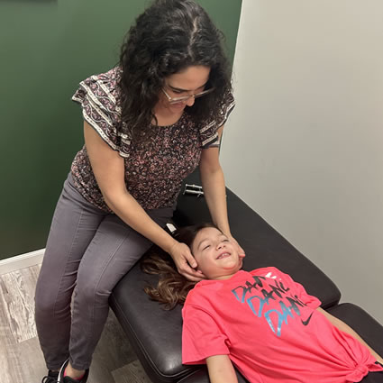 Dr. Ilean Santos adjusting child